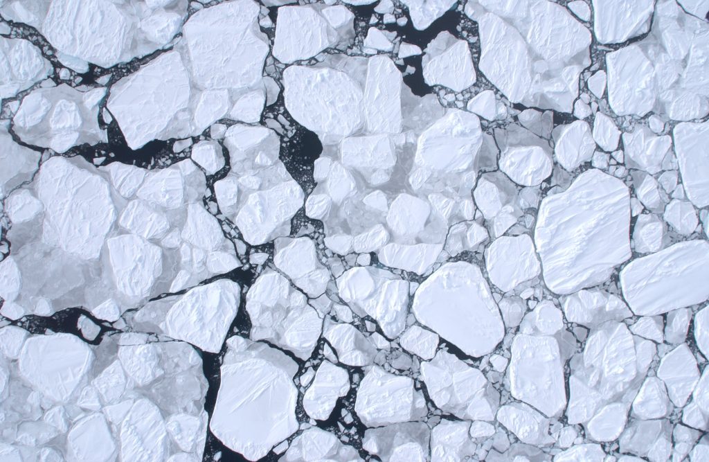 an aerial view of broken sea ice